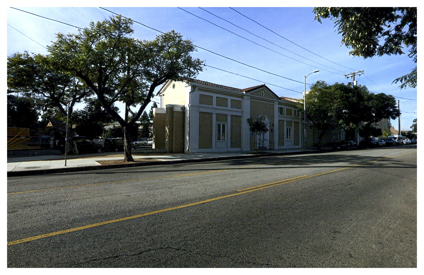 Completed overall front view of Melrose Baptist Church, the front gated landscaped courtyard, and the school, from right to left.