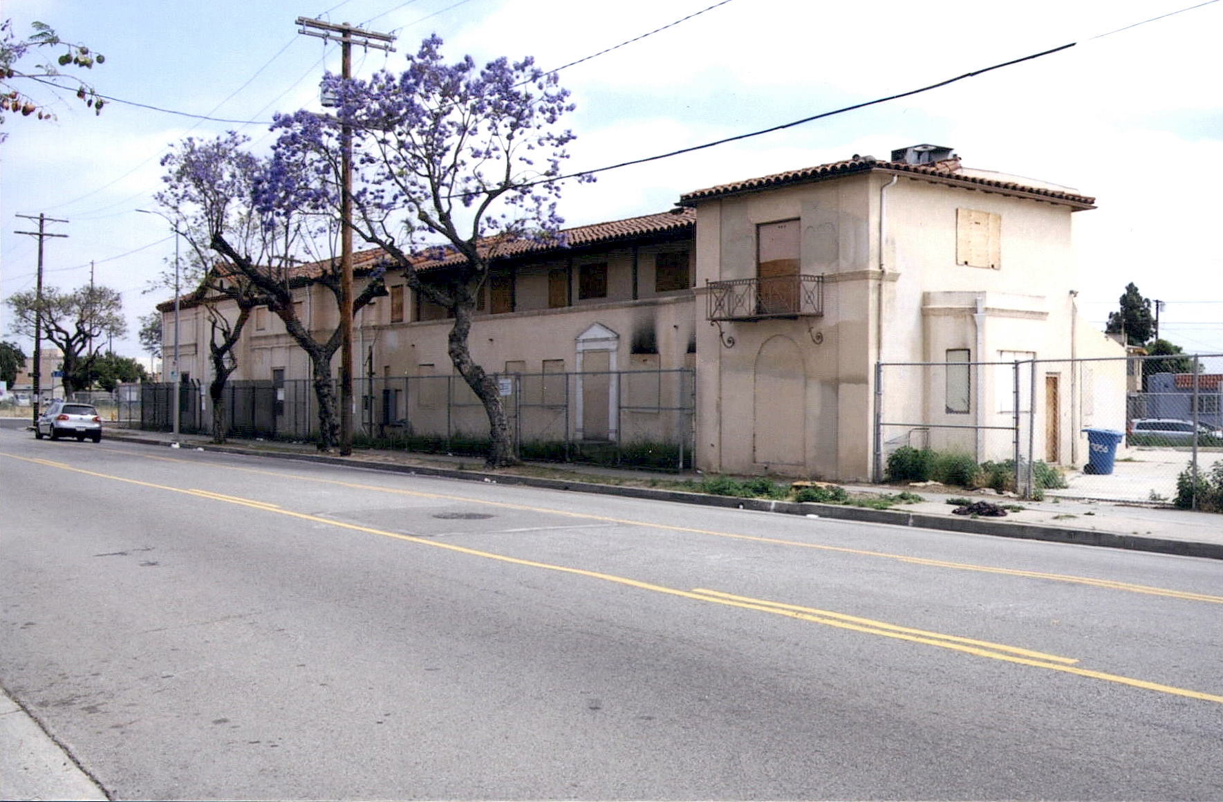 Before: same oblique view of street facade before apartment building new construction on site.