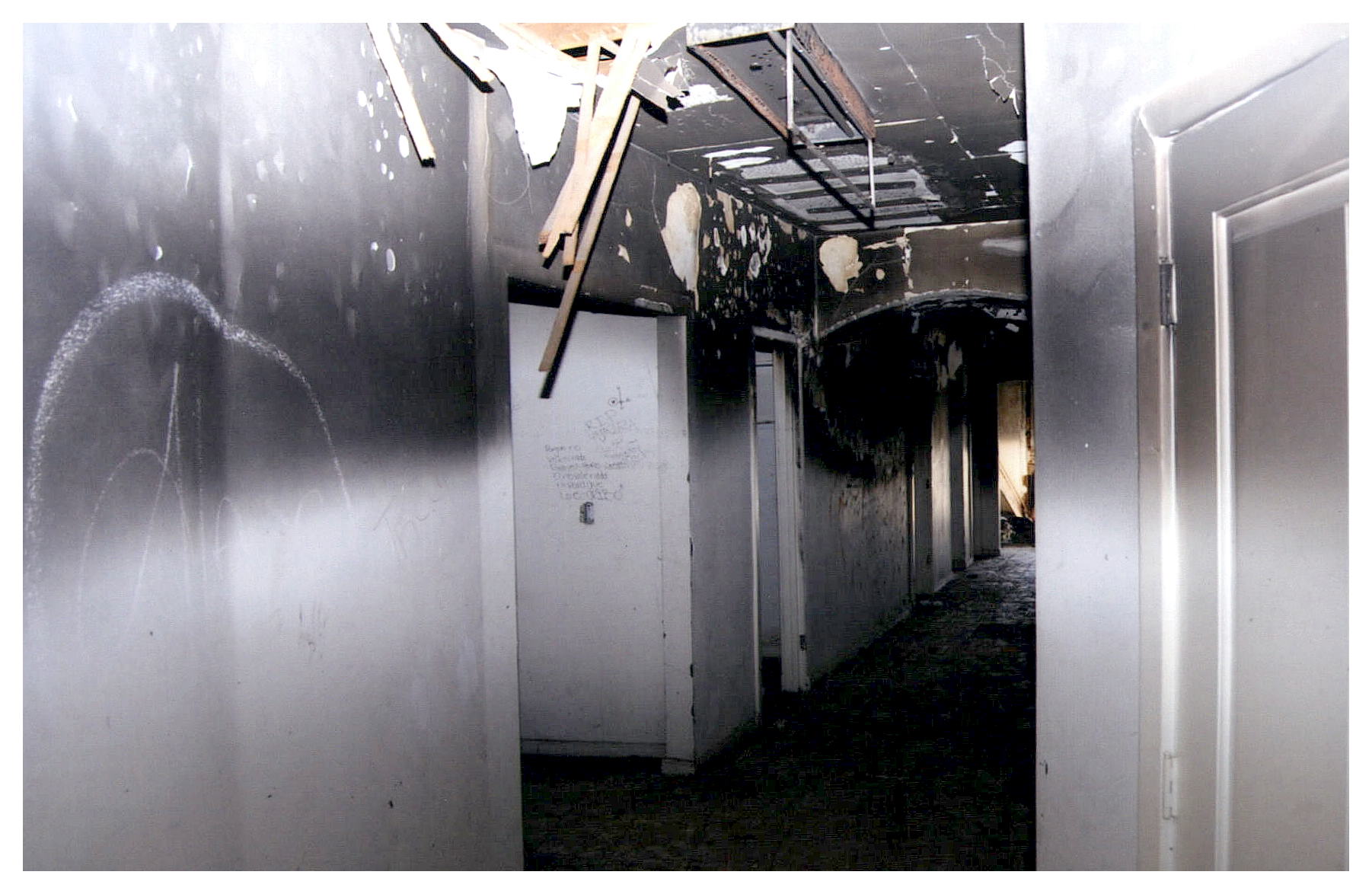 Before: view of hallway with damaged dropped ceilings.