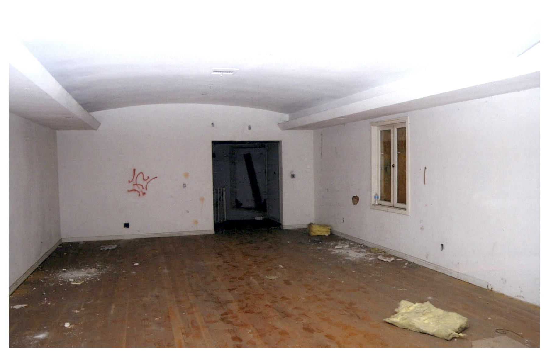 Before: opposite view of circulation space with doorway at end.