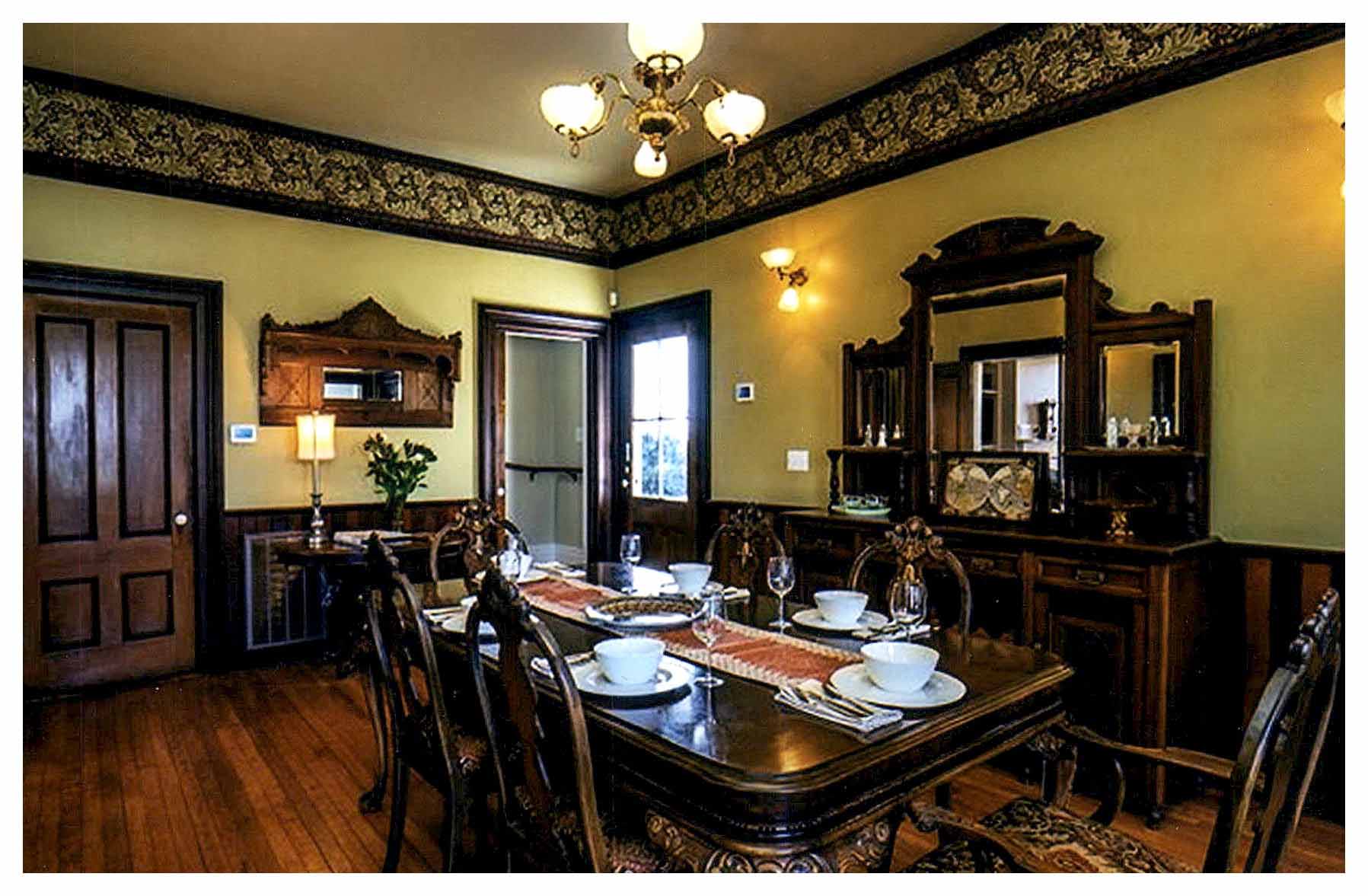 After:  another view of the dining room showing the side entrance and refinished walls and floors.