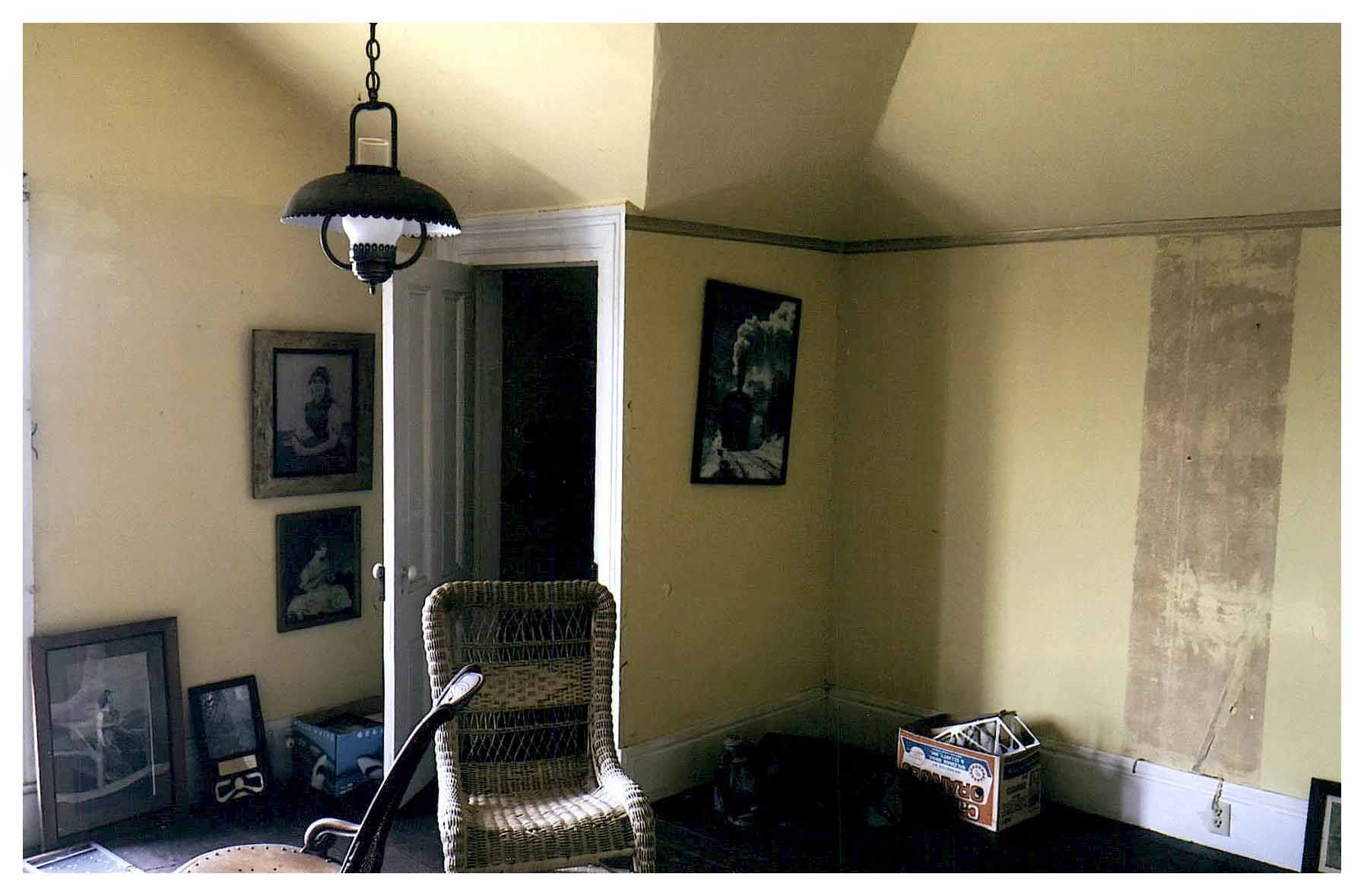 Before: closer view of closet and yellow painted walls and sloped ceiling.