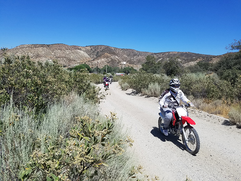 Group of people riding OHV motorcycles