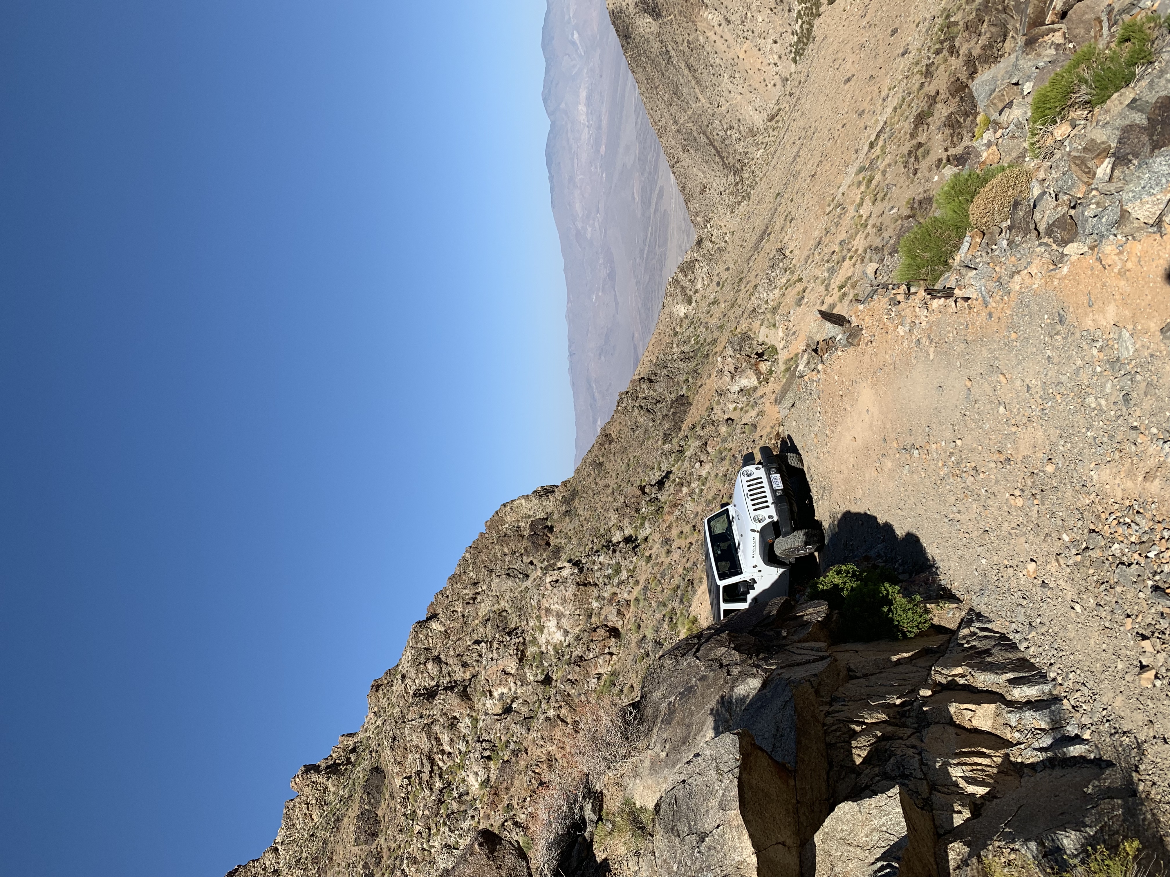 jeep driving on dirt trail in the desert