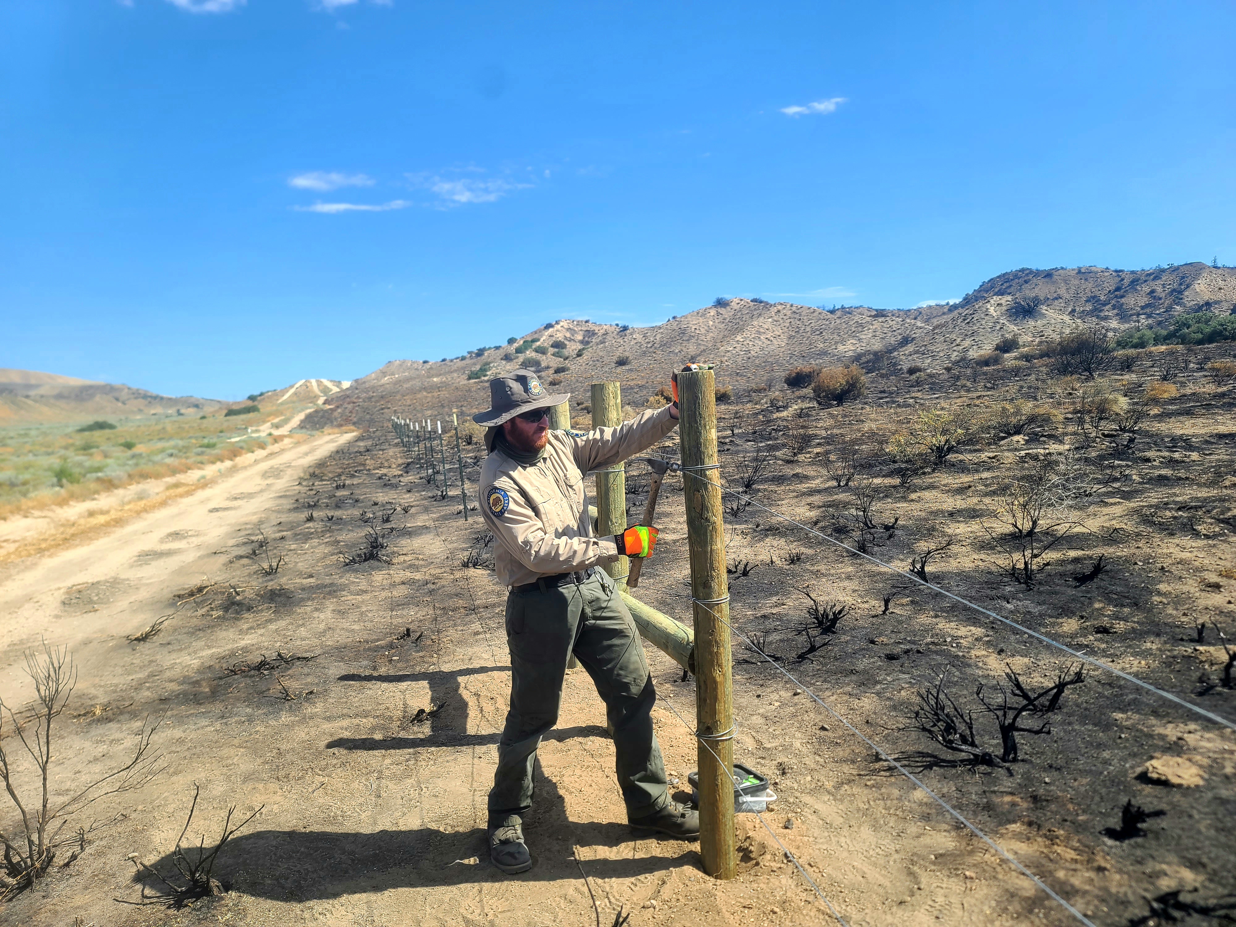 Hungry Valley SVRA trail crew replacing fencing that burned in the Post Fire.