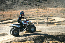 White mini quad on jump.
