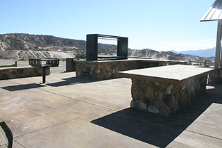 Hungry Valley SVRA Pavilion BBQ Area with large food preparation table, bbq, and Santa Maria style bbq pit