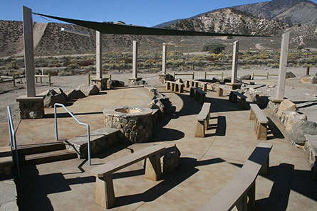 Hungry Valley SVRA Pavilion Picnic Area with a fire pit, many benches, and a sail shade