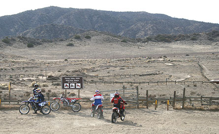 Four dirtbikes overlooking Hungry Valley SVRA.