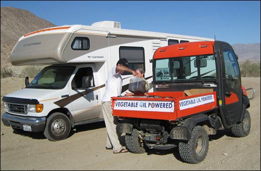 Image of a park visitor with an RV pouring used vegetable oil into a container in the back of a Kubota UTV with a sign that says Vegetable oil powered.