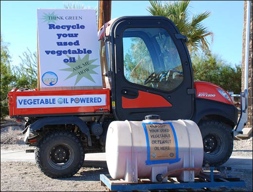 Photo of Kubota UTV with large sign that says Think Green. Recycle your used vegetable oil. Ask me how. Vegetable oil powered. A large tank half full of vegetable oil says recycle your used vegetable or peanut oil here.