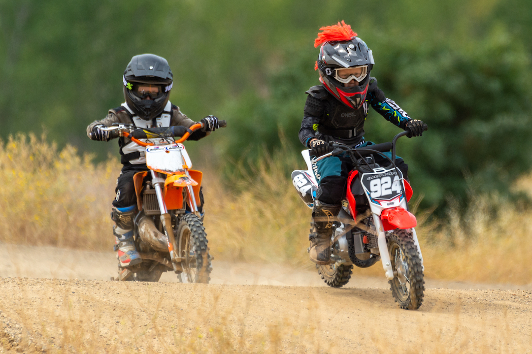 2 children on mini dirt bikes