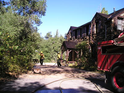 The Dyar house before the fire, being wet down
