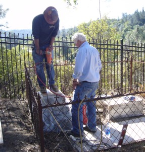 Staff making repairs to a monument in Shasta SHP Catholic Cemetery 