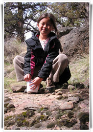 A girl opening a geocache
