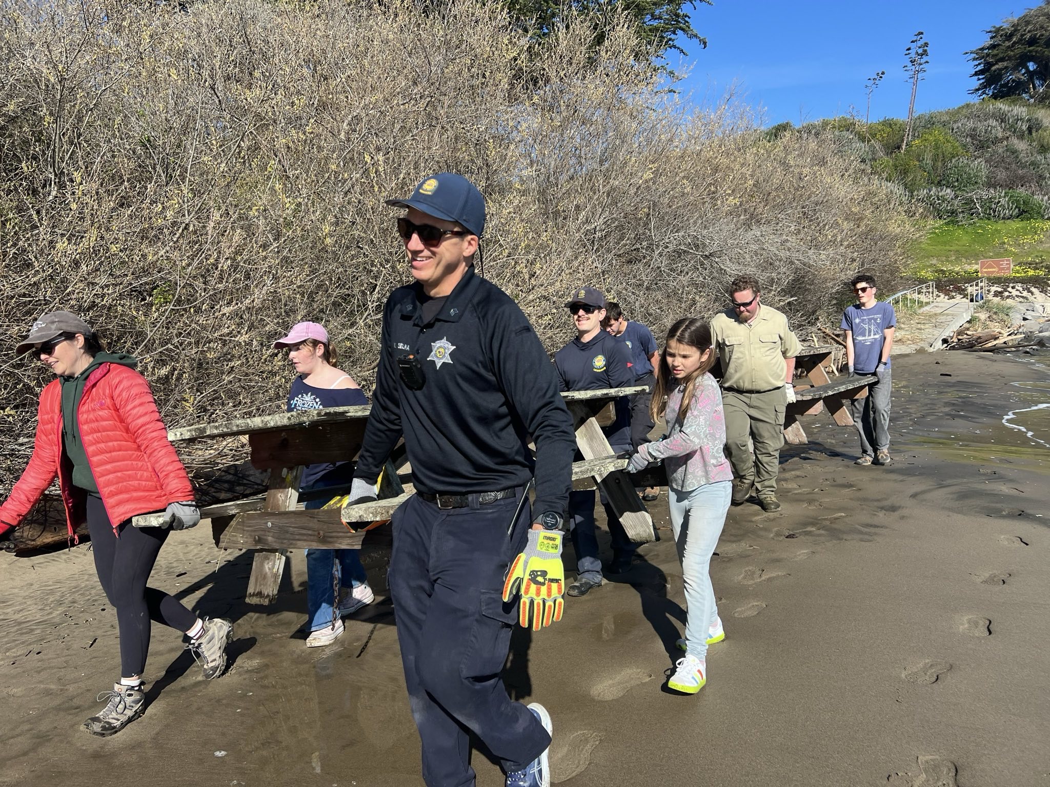 Carrying picnic tables to Quarry Beach.