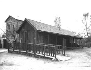 View of the north face of Powerhouse and Blacksmith Shop from top of Forebay