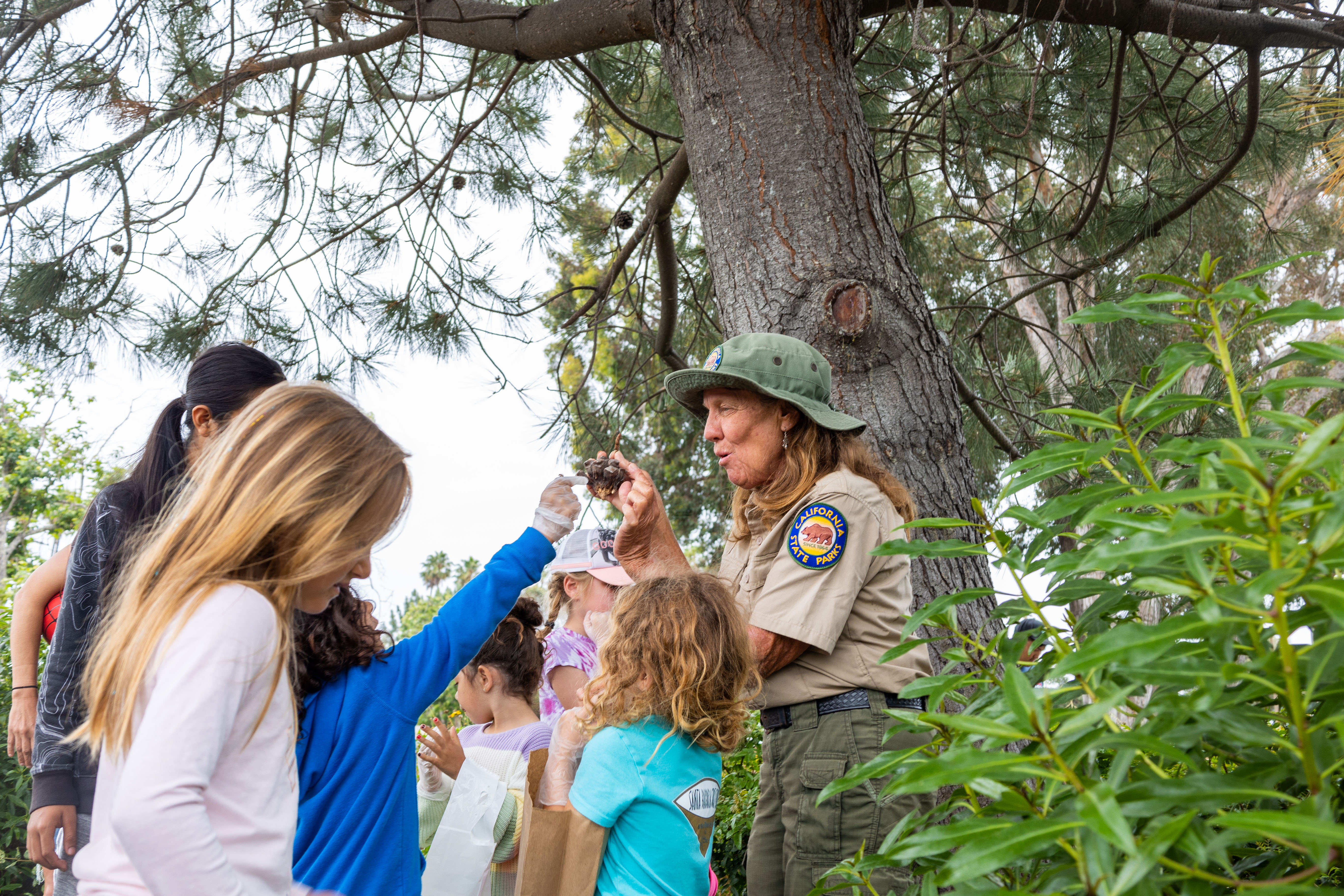 Staff handing visitor a trash picker