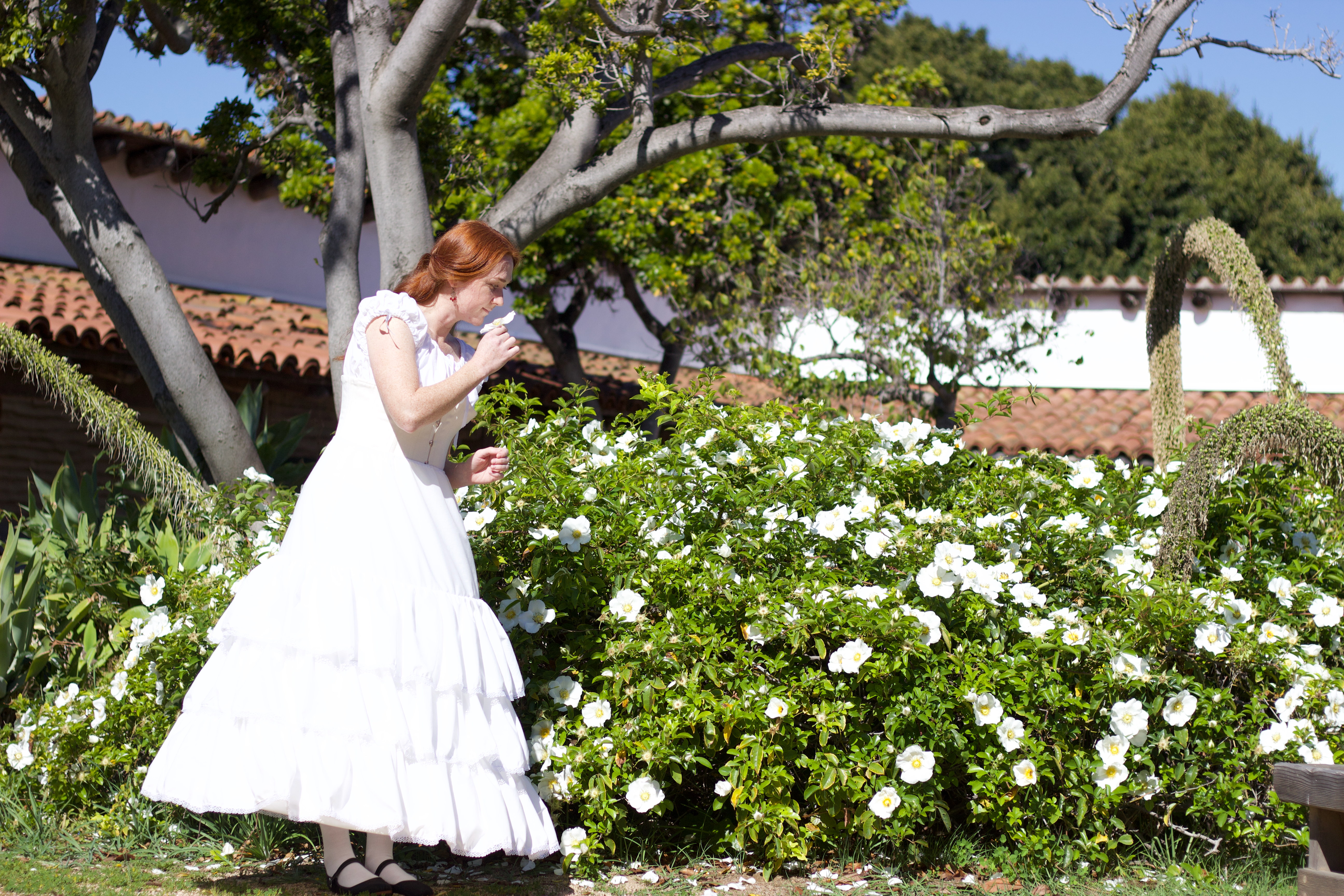 Photo of a woman in period undergarments in the Casa de Estudillo garden