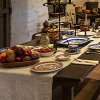 Historic table set for dinner with period accurate silverware and fixings