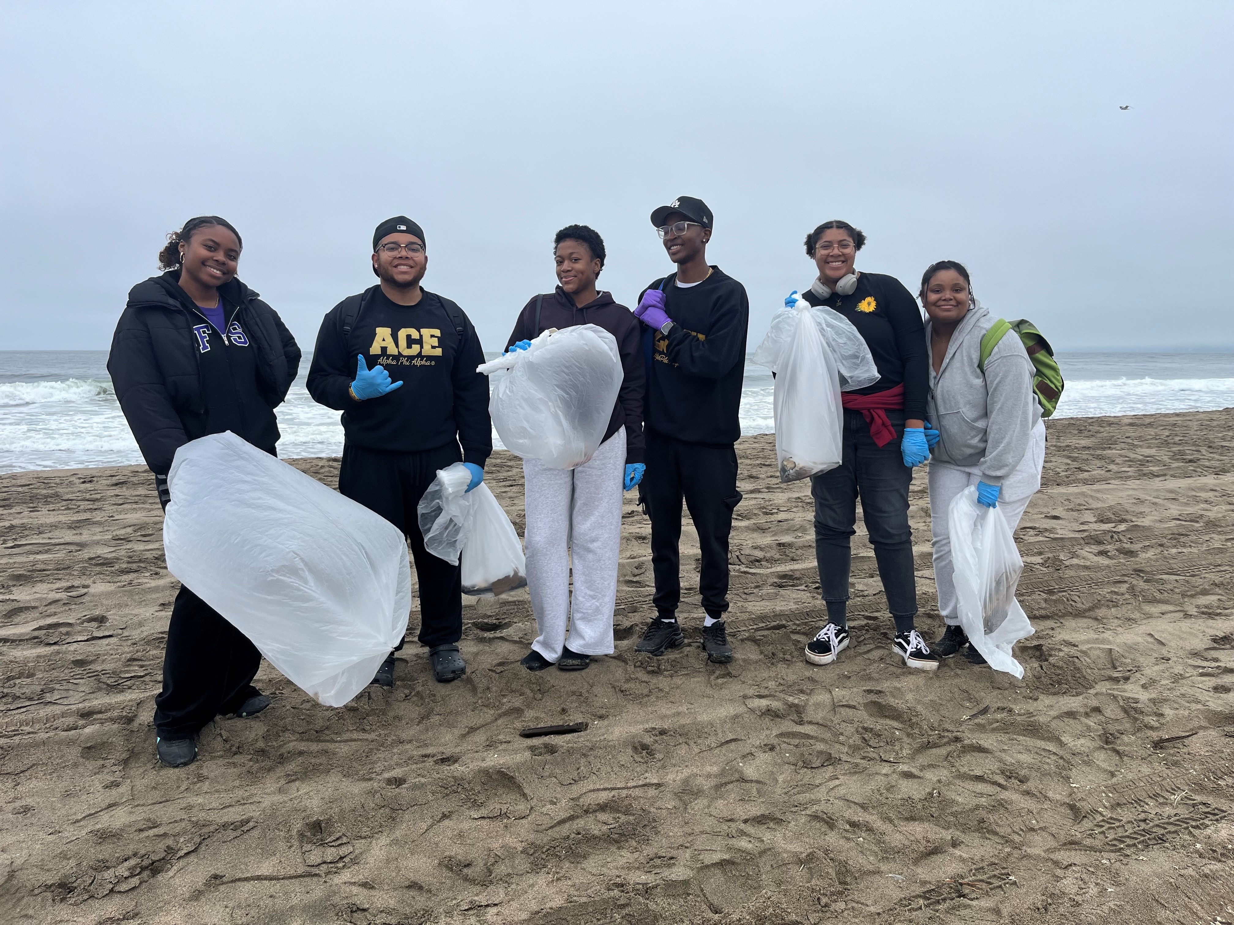 ).                Volunteers with Golden Gate Parks Conservancy help clean up Ocean Beach in San Francisco. 