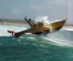Picture of boat going thru a large wave.