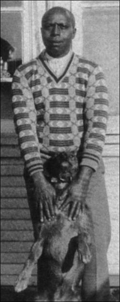 Frank Milner in front of his barbershop in Tulare, California.